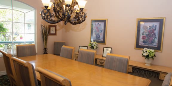 a dining room with a table and chairs and a chandelier